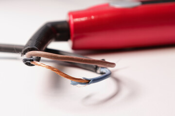 Damaged power cord for household appliances. Broken cord from heavy use. The appliance needs to be repaired. Soft focus - obrazy, fototapety, plakaty