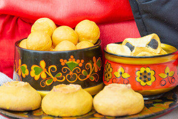 Fresh homemade baked pastries in a wooden bowl.