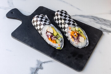 Fusion sushi burritos on black board