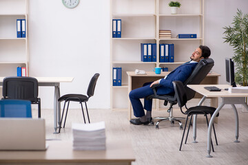 Young male employee and too much work in the office