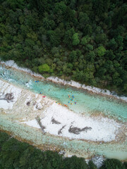 Aerial shot of kayakers in the river Soca in Slovenia.