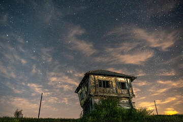 Ruins of old house under clouds night sky