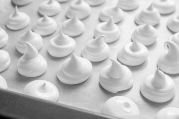 Homemade meringue cookies. White sweet meringue. Tray of meringues.