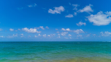 Fototapeta na wymiar Tropical ocean views of turquoise water and blue skies with puffy clouds