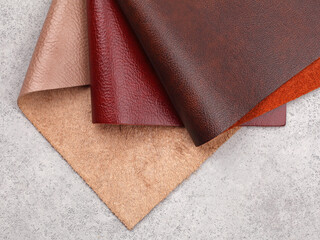 Natural leather textures samples on gray stone background