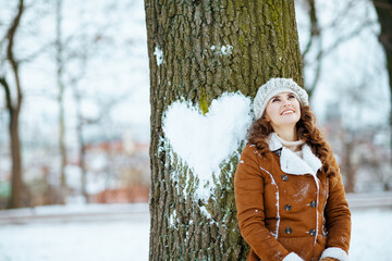 happy 40 years old woman outdoors in city park in winter