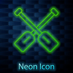 Glowing neon line Paddle icon isolated on brick wall background. Paddle boat oars. Vector