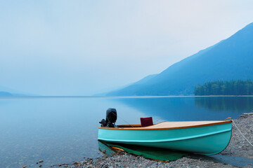 Overview of Lake McDonald after sunset with a boat in foreground. Lake McDonald is the largest lake...