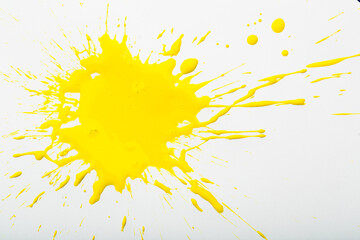Spilled yellow paint spots on paper, colorfull artistic image on white background