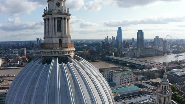 Backwards reveal of large dome and lantern on top of baroque Saint Pauls Cathedral. Old Anglican church near River Thames. London, UK