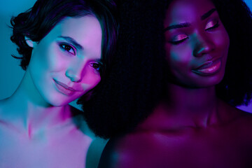 Fototapeta premium Photo of two charming positive ladies closed eyes dream perfection aesthetic isolated on neon light background