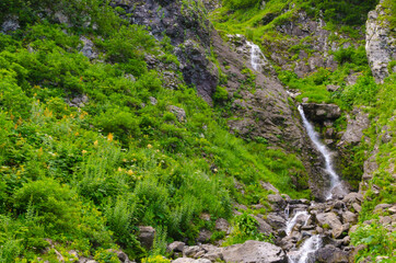 Small waterfall in the mountains in summer