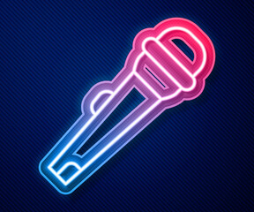 Glowing neon line Microphone icon isolated on blue background. On air radio mic microphone. Speaker sign. Vector
