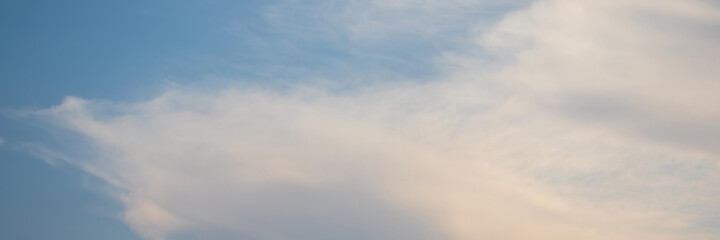 Blue sky background with clouds. Wide panoramic background for design.