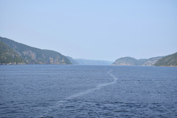 Fototapeta na wymiar Tadoussac, Quebec, Canada: View of the Saguenay Fjord from the 138 ferry, looking westward