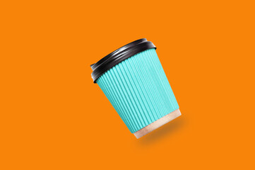 paper coffee cups on orange background.	