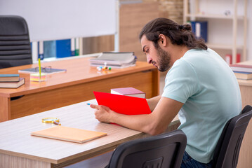 Young male student in the classroom during pandemic