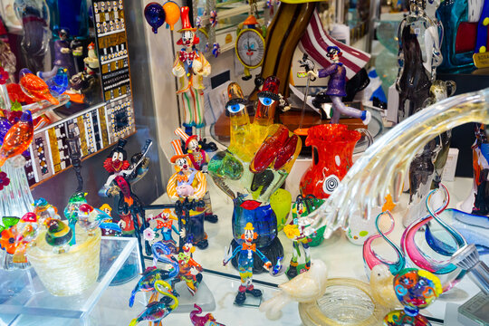 Colorful souvenirs from famous Murano glass on showcase of gift shop in Venice..