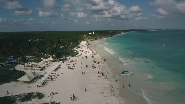 4K Epic Aerial shot of playa Tulum Mexico beach flying over water ocean