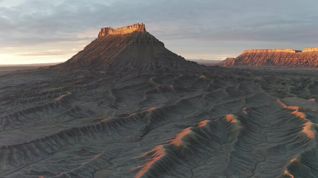 4K Aerial drone shot of Factory Butte mountain earth textures Utah at sunset