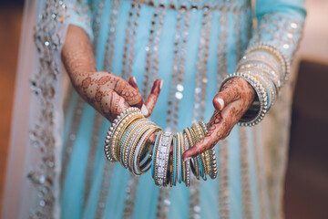 Indian bride's wearing her wedding bangles hands close up