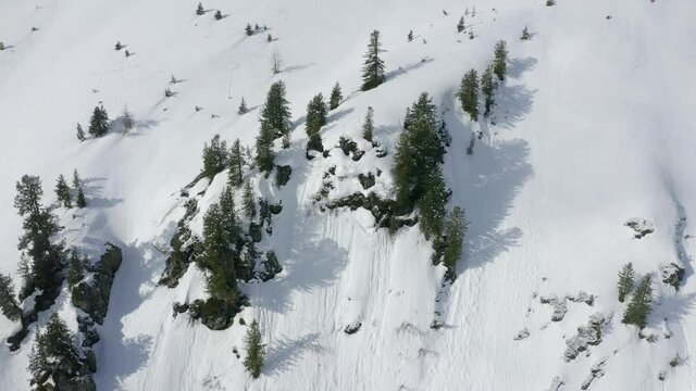 Bird&rsquo;s Eye view Ascending shot, Scenic view of snow covered hill in Tyrol, Austria, sunlight in the background.