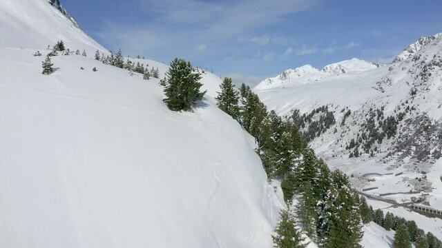 Aerial view moving forward shot, on the side of K&uuml;htai Glacier in Tyrol, Austria, river in the middle of the mountain.