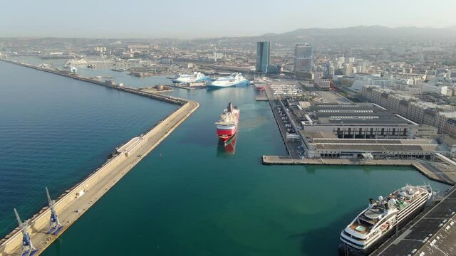 Aerial view of a cruiseliner leaving Marseille, sunrise in France - tracking, drone shot