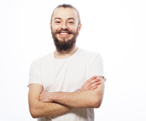 Lifestyle and people concept: Bearded young man wearing white t-shirt with his arms crossed over white background