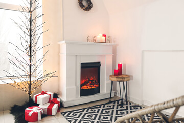 Stylish interior of living room with fireplace and creative Christmas tree