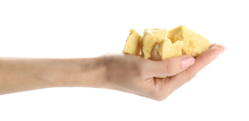 Female hand and pieces of cocoa butter on white background