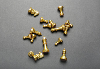 Golden chess pieces on grey background