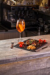 Wineglass and steak with vegetables in restaurant