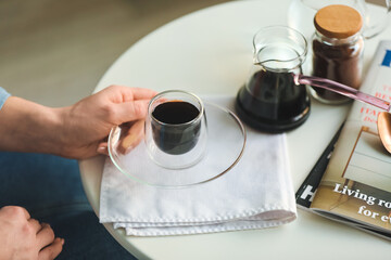 Woman with cup of hot turkish coffee at table, closeup