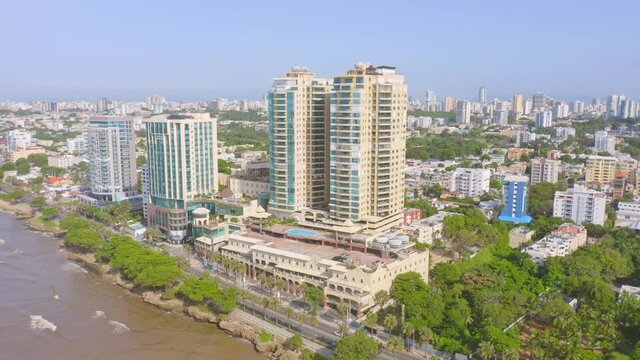 Tall hotel on tropical shore of Santo Domingo, Malecon Center, aerial