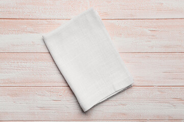 Fabric napkin on light wooden background
