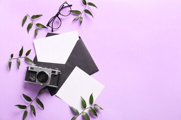 Composition with envelope, blank cards, eyeglasses and photo camera on color background