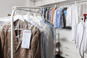 Rack with clothes at modern dry-cleaner's