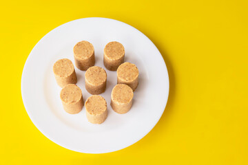 Top view of a typical brazilian sweet.  Pacoca in the white plate. 