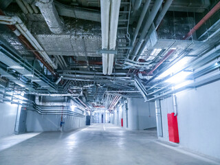 Indoor space next to stadium. Corridors for employees of concert venue. Engineering networks are stretched under ceiling. Engineering premises near concert venue. Engineering corridors.