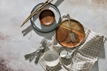 Fototapeta na wymiar Different plates, forks and napkin on light background