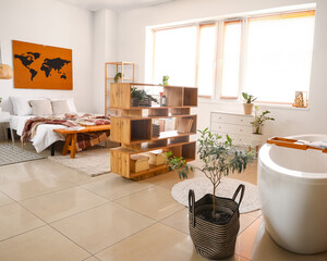 Interior of stylish bedroom with book shelf