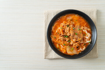 Korean udon ramen noodles with pork in kimchi soup