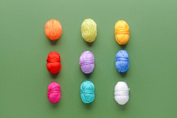 Colorful knitting yarn on green background