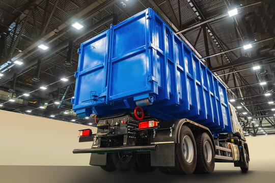 Blue Truck. Truck Under Roof Of Hangar Or Warehouse. Car For Transport Of Goods. Demonstration Machines.  Garbage Collection Truck Body. Demonstration Of Equipment For Housing And Communal Services