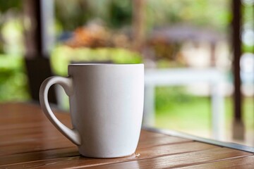The coffee mug placed on the wood table top