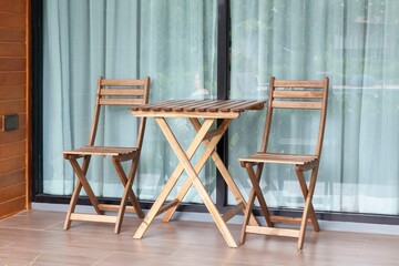 Brown wooden chairs and brown wood table on the balcony