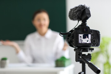 Teacher recording video for his students in classroom