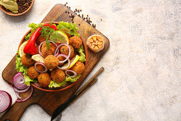 Bowl with tasty cod cutlets and spices on light background
