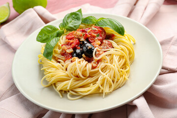 Plate with tasty Pasta Puttanesca on table
